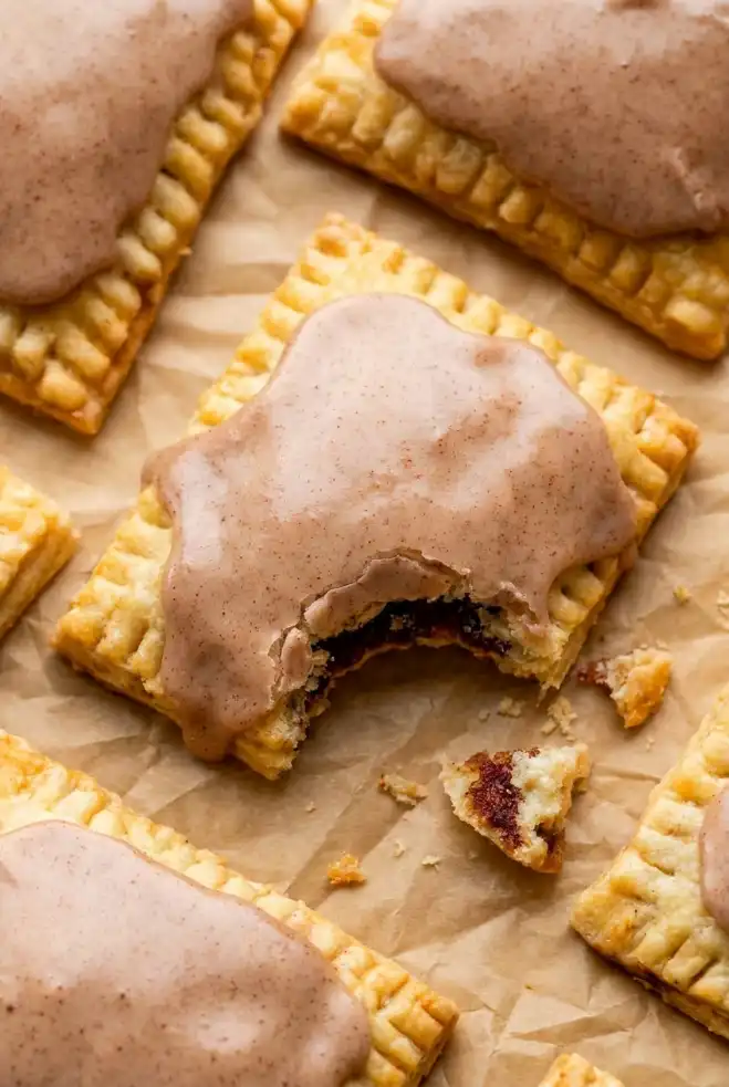Bitten homemade brown sugar cinnamon pop tarts showing flaky layers and cinnamon brown sugar filling