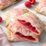 Raspberry jam pop tarts with vanilla glaze and red sprinkles
