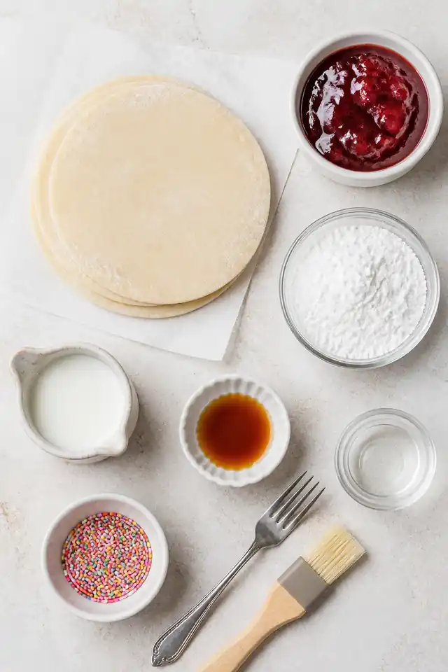 Air Fryer Strawberry Pop Tarts 3 Ingredients for air fryer strawberry pop tarts with pie crust, strawberry jam, powdered sugar, milk, vanilla, water, and sprinkles