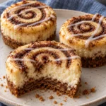mini cinnamon roll cheesecakes with visible cinnamon spirals and thin vanilla glaze