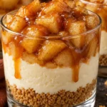 Caramel apple cheesecake cups with graham crumbs, creamy filling, cinnamon apples, and caramel