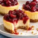 mini cherry cheesecakes with baked vanilla centers and glossy homemade cherry topping